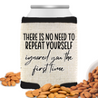 A beige can cooler with black trim and text that reads 'There is no need to repeat yourself; I ignored you the first time' on a white background, with a can behind it and almonds scattered around.