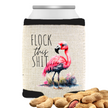 A can cooler with tex in a sarcastic saying and a flamingo design, alongside a pile of almonds. The cooler has black trim and a natural linen color, with the text 'Flock This Shit' printed on it.