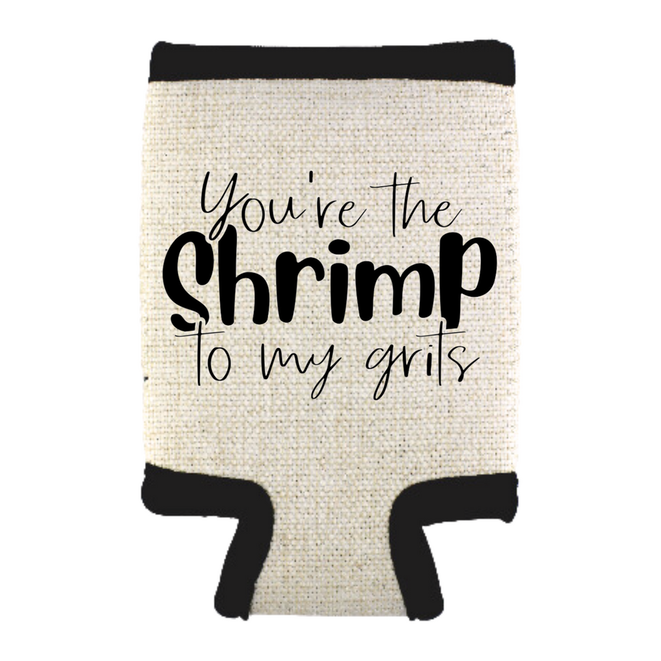 A beige can cooler with the phrase “You’re the Shrimp to My Grits,” standing on a white background.