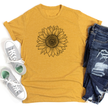 Yellow t-shirt with sunflower design, white sneakers, and blue jeans on a white background