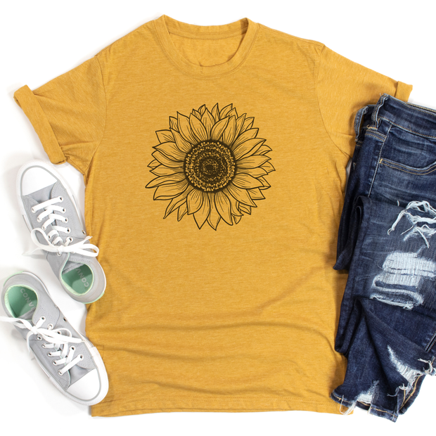 Yellow t-shirt with sunflower design, white sneakers, and blue jeans on a white background