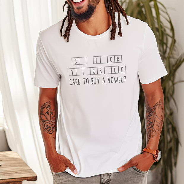 Man wearing a white t-shirt with text, standing indoors with plants in the background