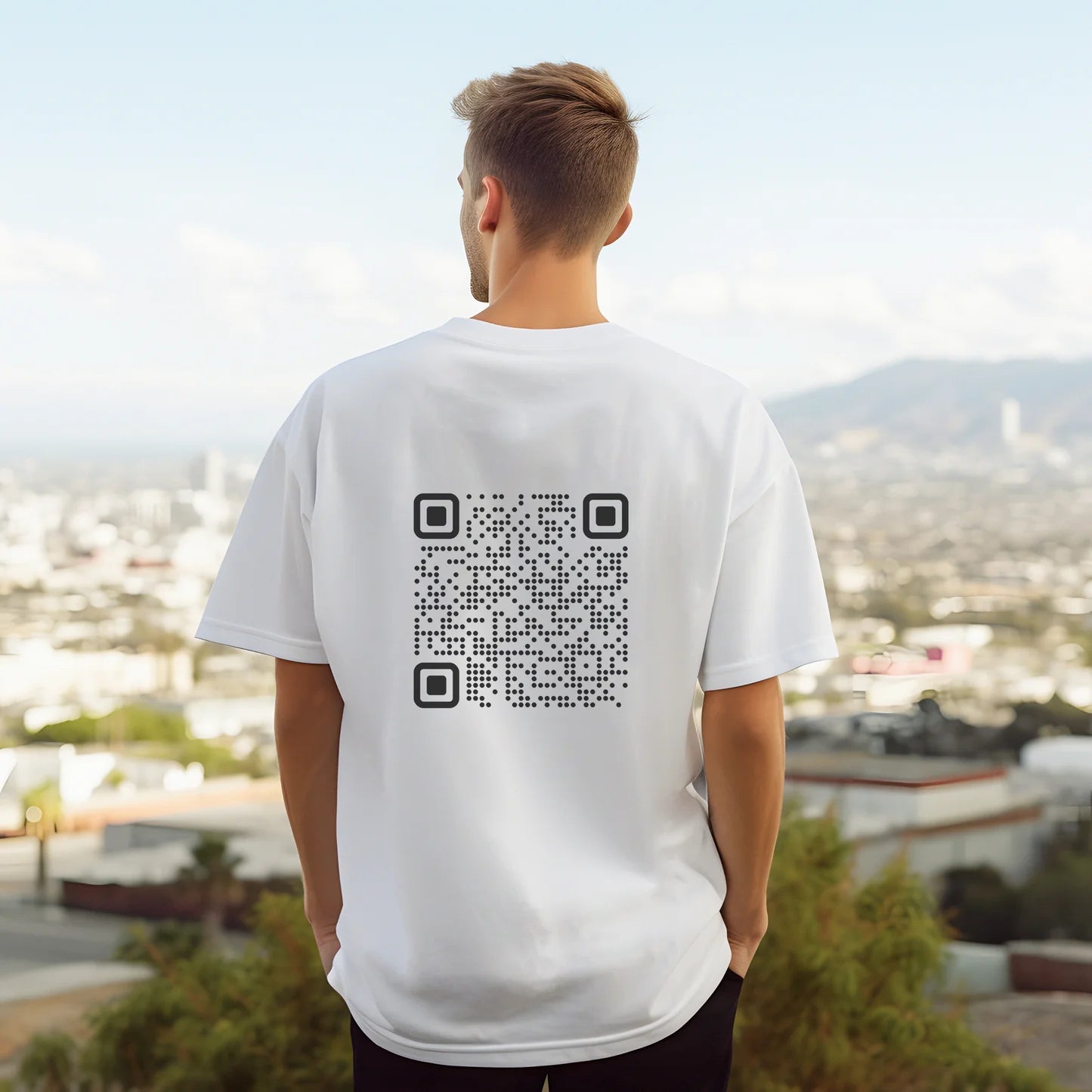 Person wearing a white t-shirt with a QR code on the back, standing against an urban landscape.