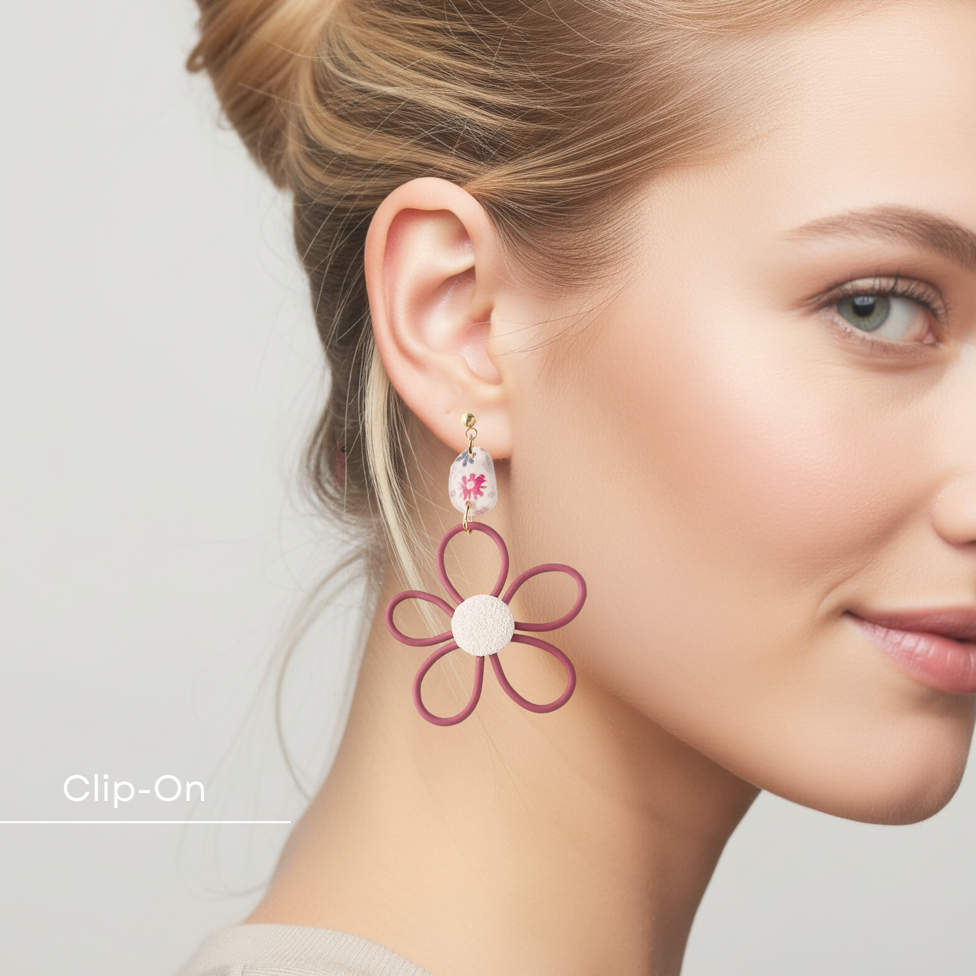 Woman wearing a floral earring with a plain background