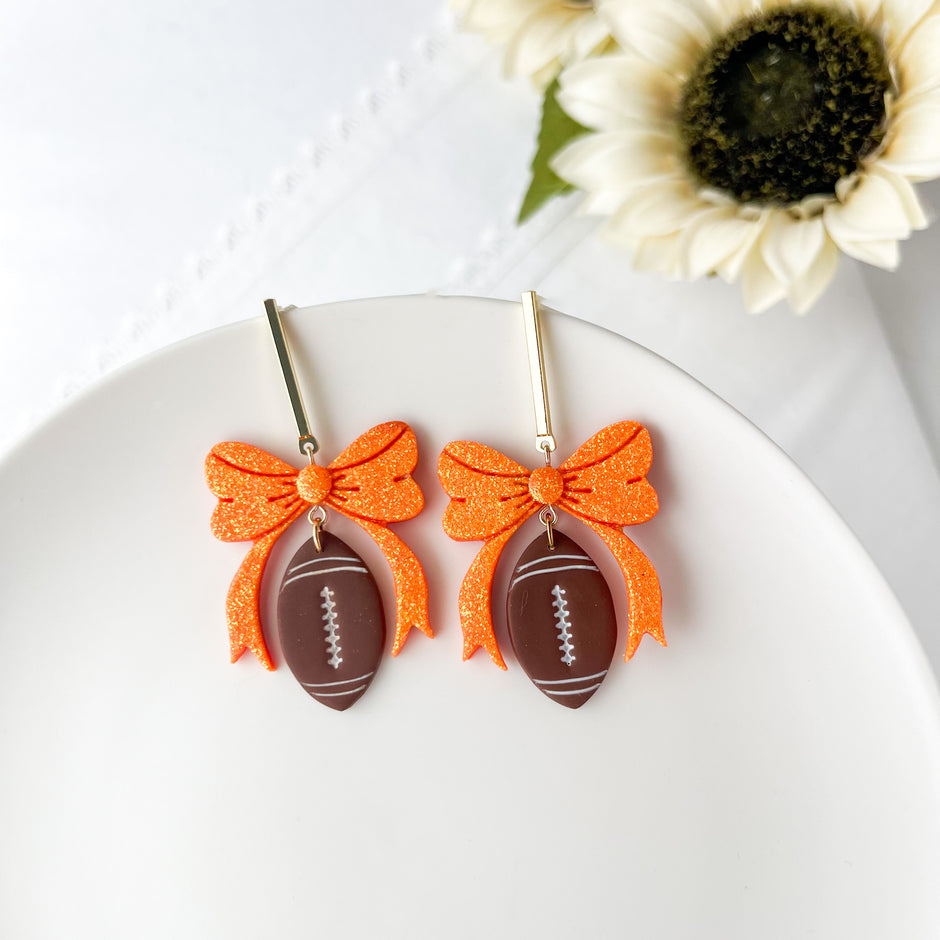 Dangle Football With Bow Lightweight Earrings | Sports Polymer Clay Jewelry | Whimsical Clip-On Earrings Option