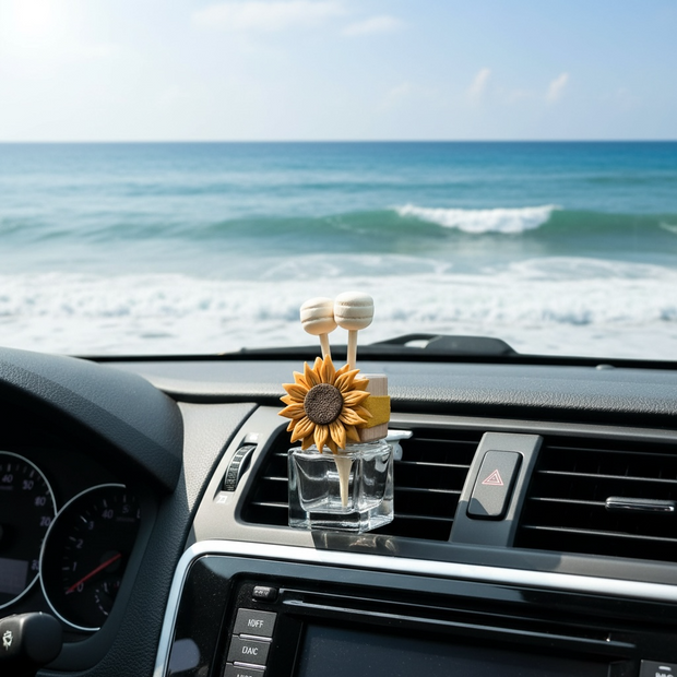Car air freshener with sunflower design on a car dashboard with ocean view