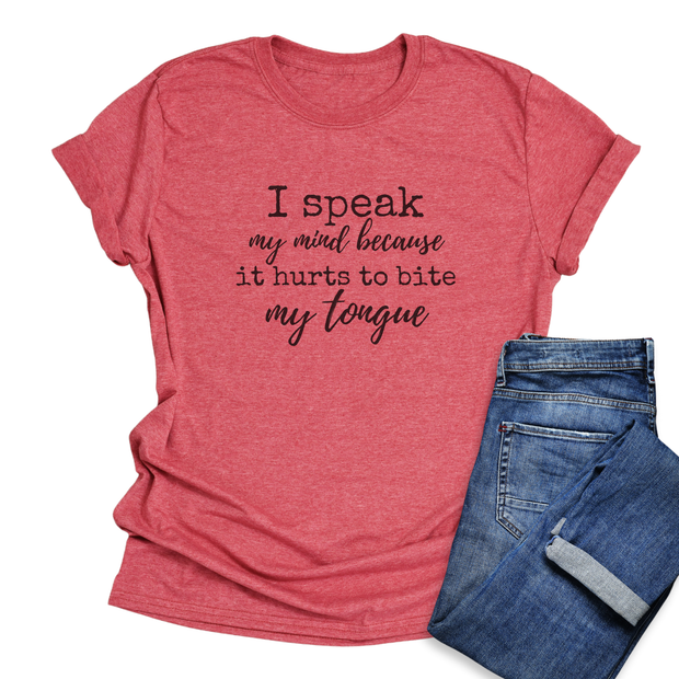 Red t-shirt with humorous text  " I speak my mind because it hurts to bite my tongue" and blue jeans on a white background