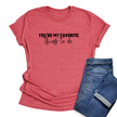 Red t-shirt with 'You're my favorite thing to do' text and blue jeans on a white background