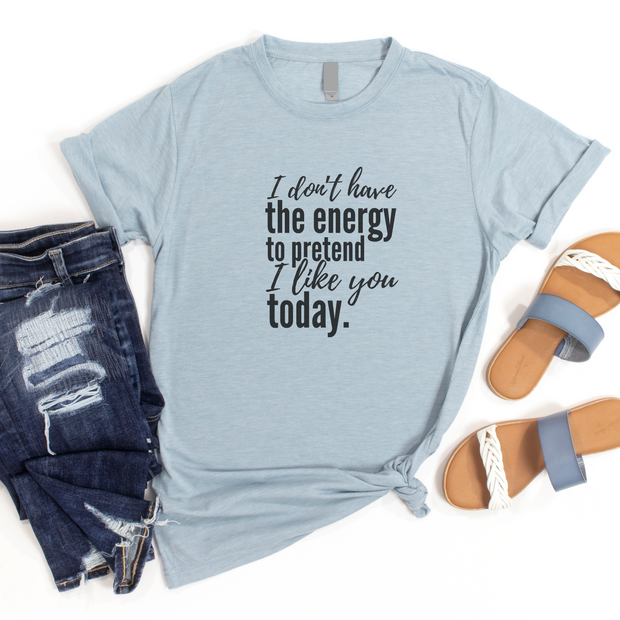Light blue t-shirt with humorous text, paired with jeans and sandals on a white background