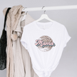 White t-shirt with 'Mama' print on a hanger against a gray background
