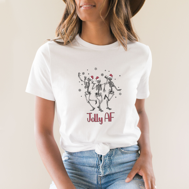 Person wearing a white t-shirt with skeletons and 'Jolly AF' text.
